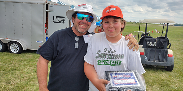 Rowdy and his dad, Jared, with his collection of awards.