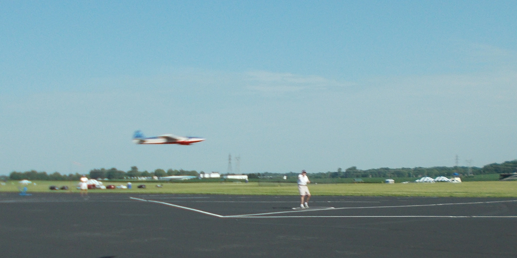 6. Frank McMillan in level flight. Notice something missing … it is the wheels. He has retracts, plus his airplane has twin elec