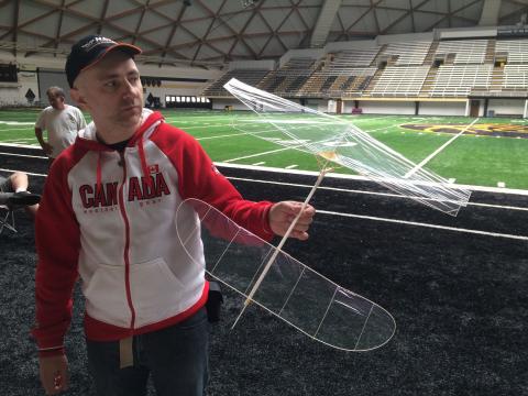 A modeler with his aircraft at the 2019 Indoor Free Flight Nats.